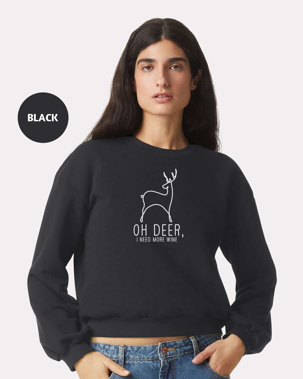 a woman wearing a black sweatshirt with a deer on it