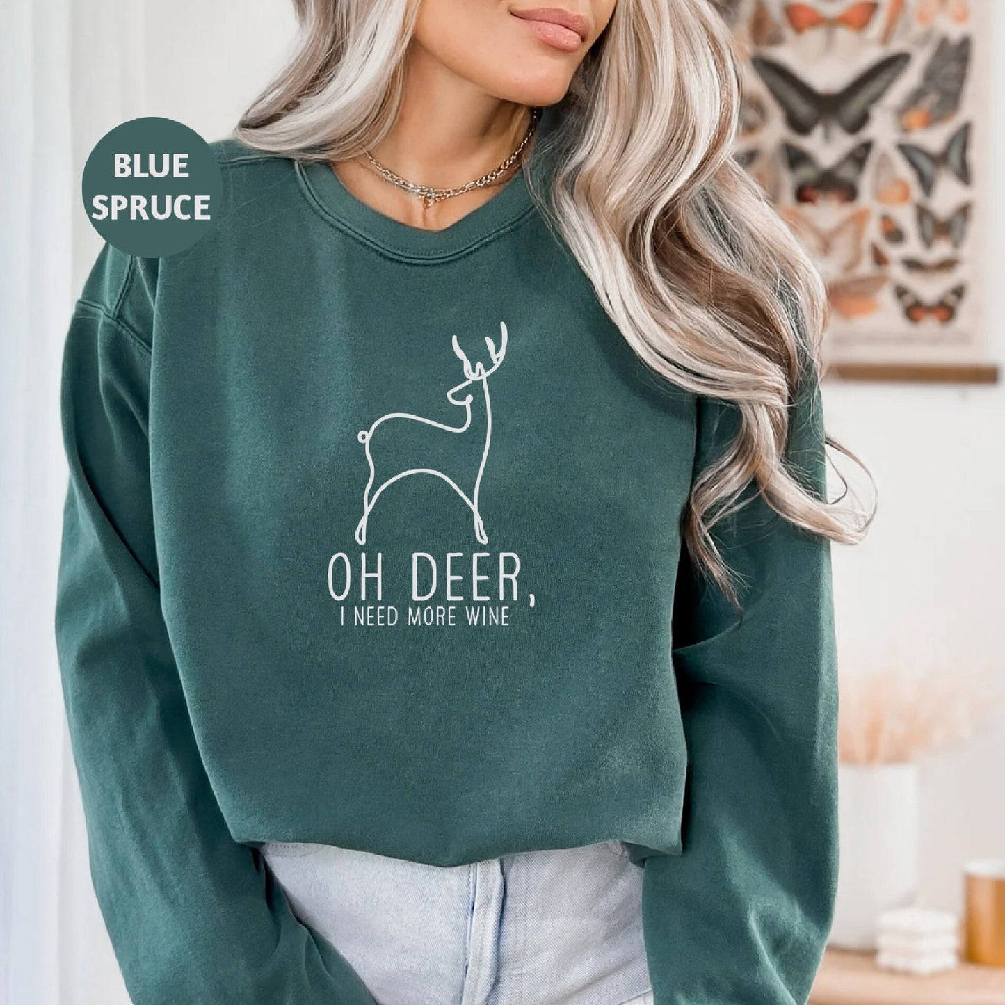 a woman wearing a green sweatshirt with a deer on it