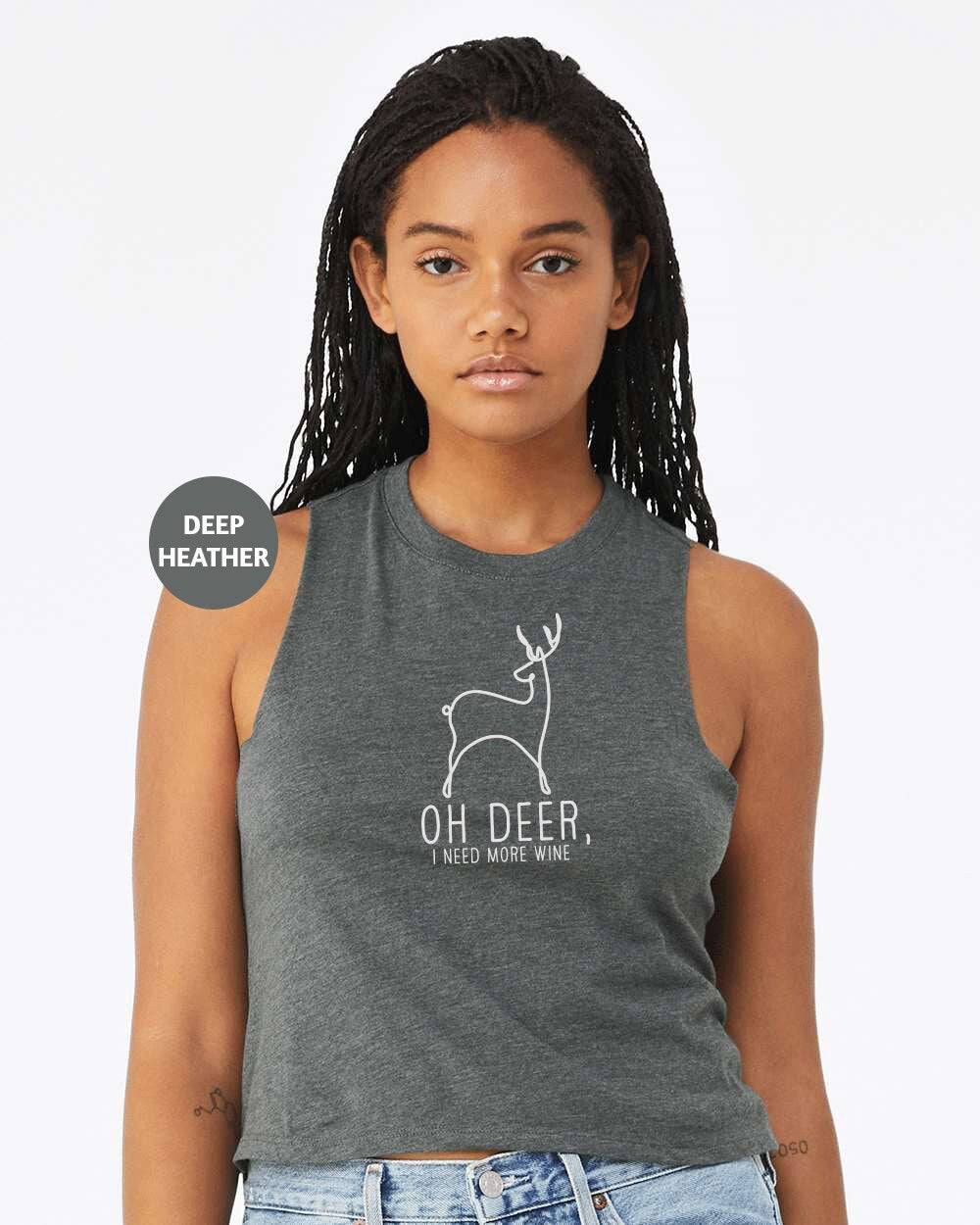 a woman wearing a tank top with a deer on it