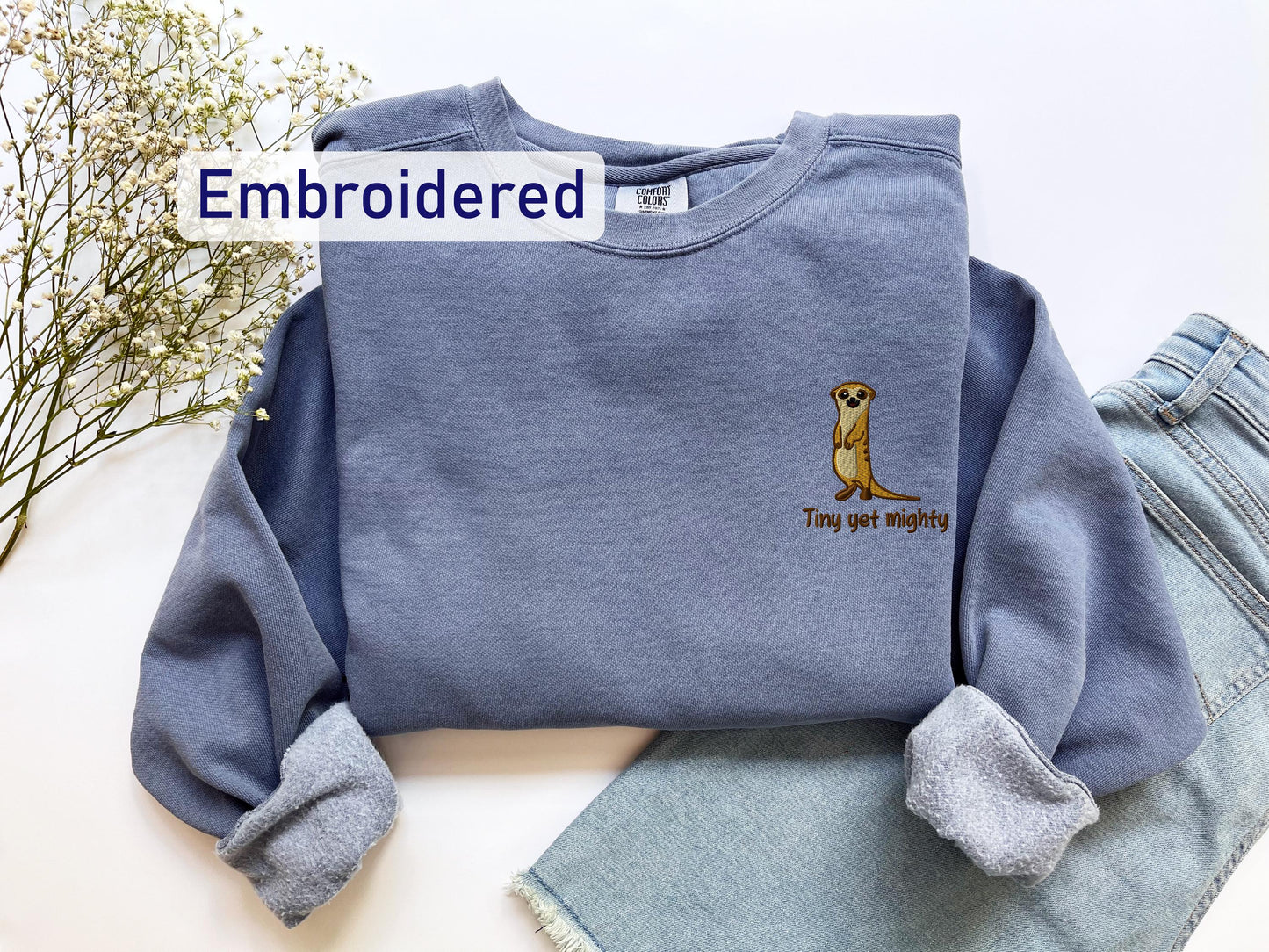 a blue sweatshirt with a dog embroidered on it