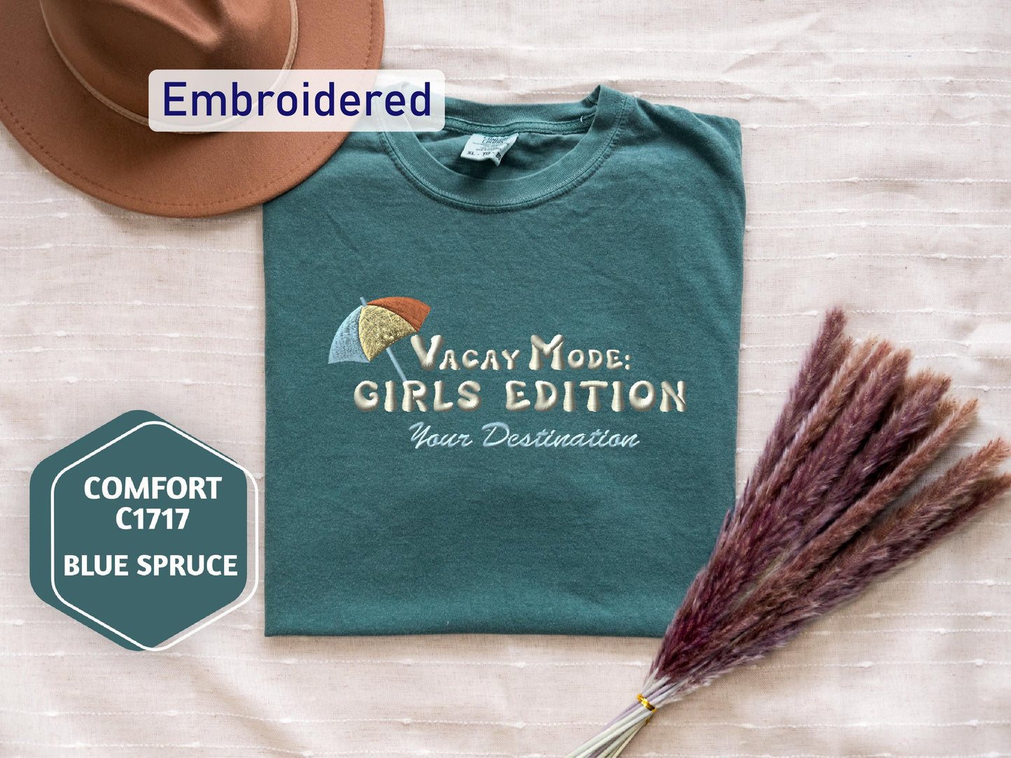 a hat, t - shirt, and broom on a bed