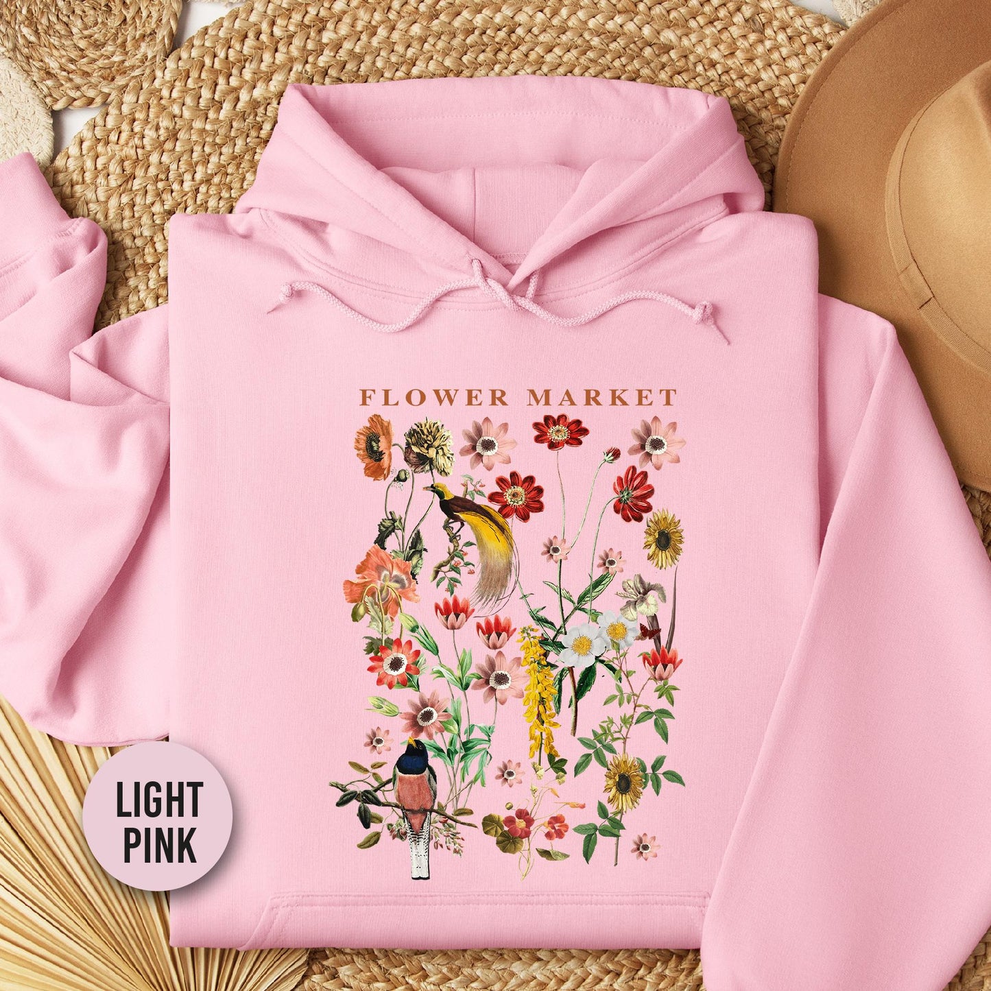 a pink hoodie with a picture of a flower market on it