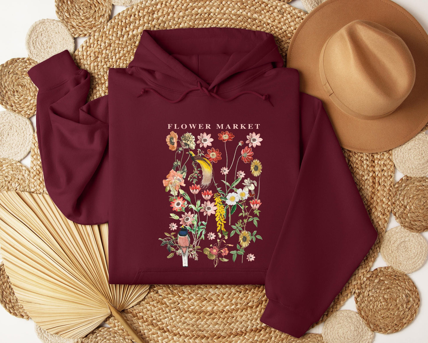 a maroon hoodie with a flower market image on it