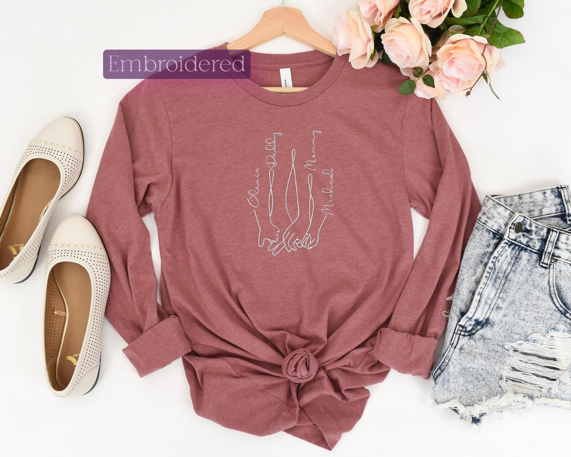 a women's t - shirt with a drawing of a hand and a pair