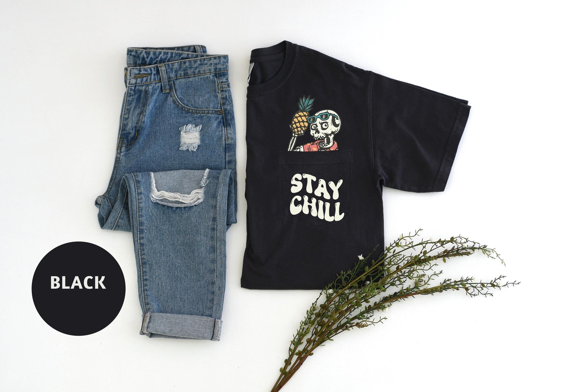 a t - shirt with a skeleton on it next to a pair of jeans