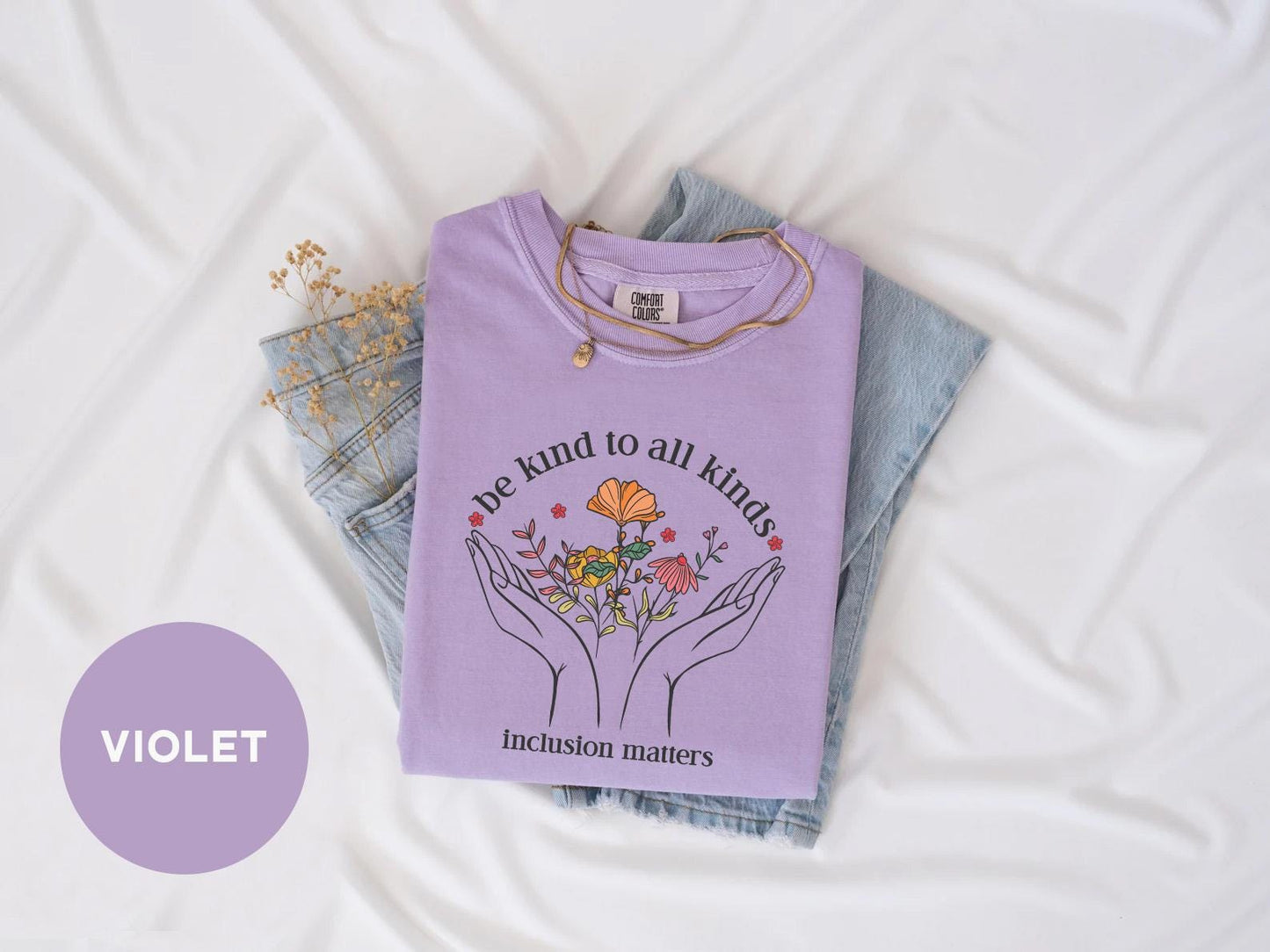a t - shirt with a picture of two hands holding flowers
