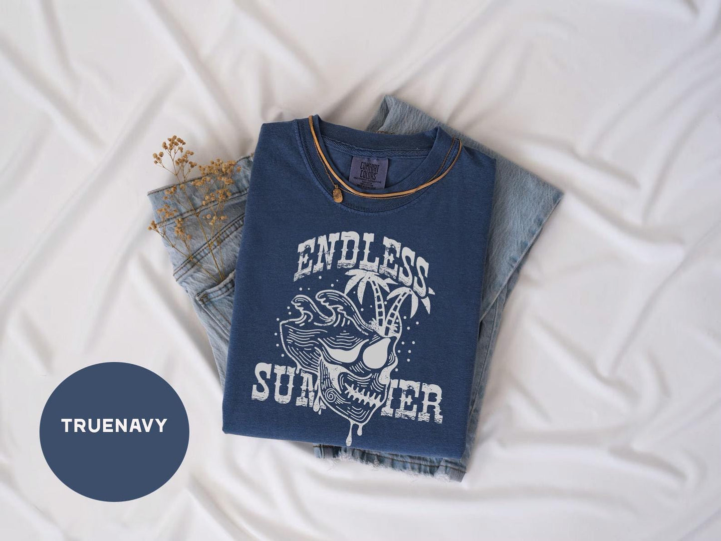 a t - shirt that says endless summer on it next to a pair of jeans