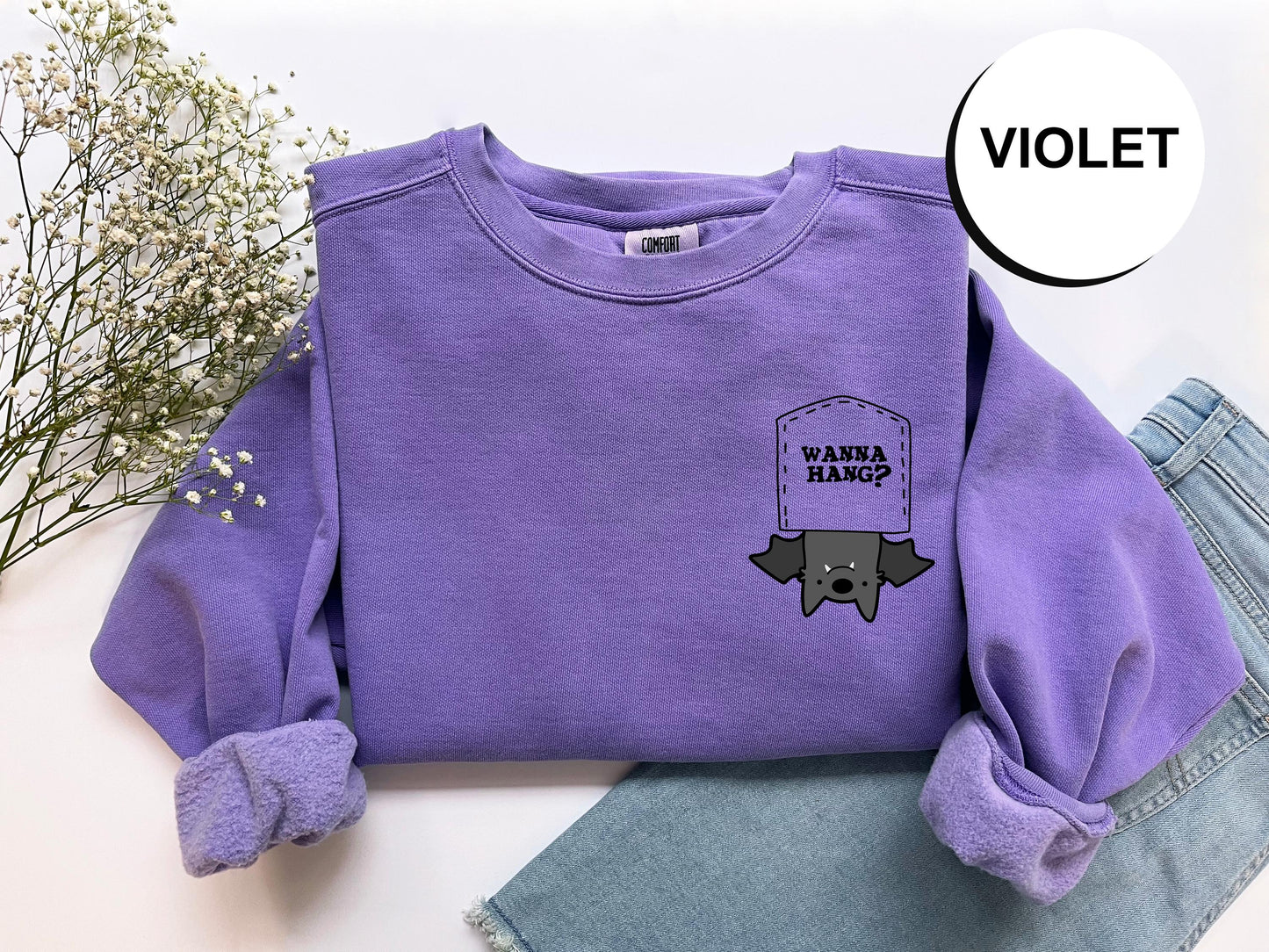 a purple shirt with a picture of a hat on it