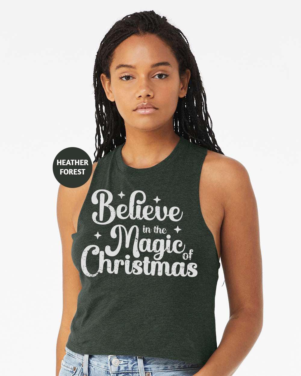 a woman wearing a tank top that says believe in the magic of christmas