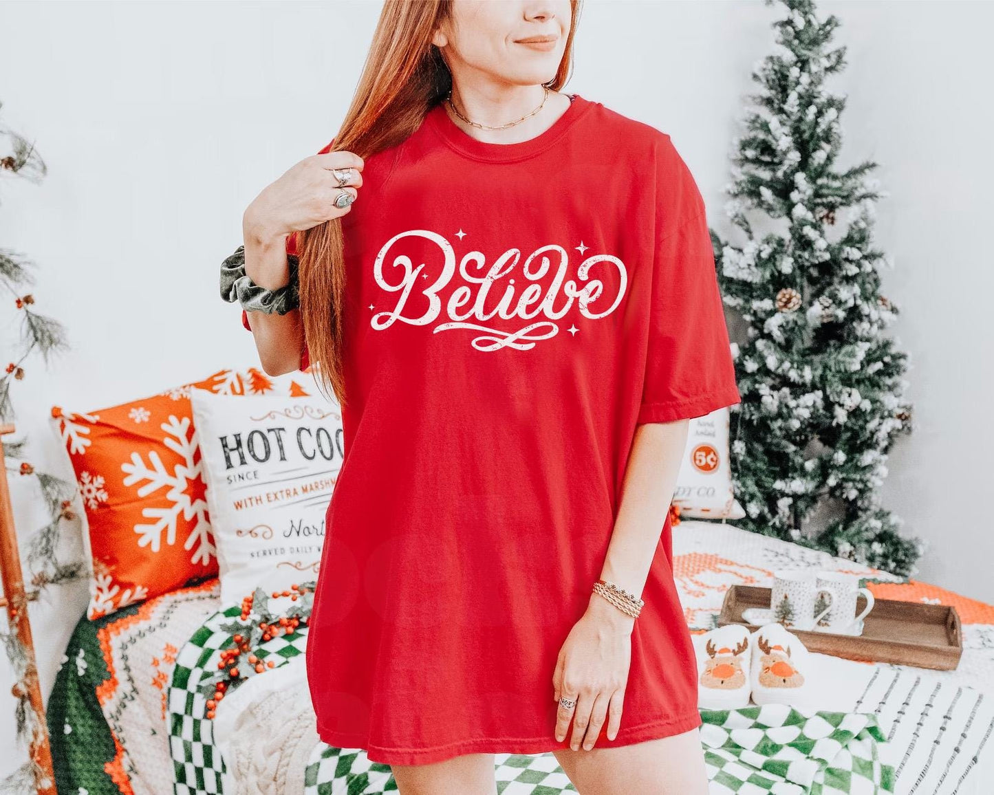 a woman standing in front of a christmas tree