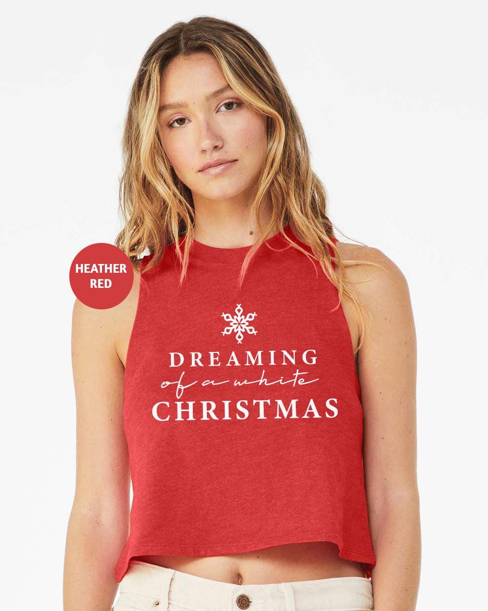 a woman wearing a red crop top that says dreaming christmas