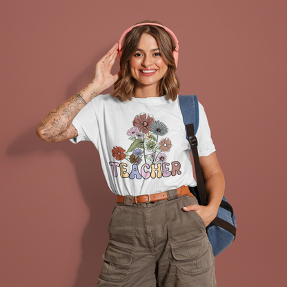 a woman wearing a t - shirt that says teacher with flowers on it