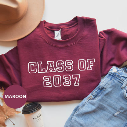 a maroon shirt that says class of 202 next to a pair of jeans and a