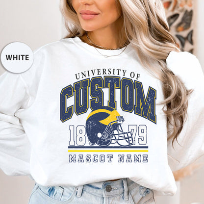 a woman wearing a white sweatshirt with a football helmet on it