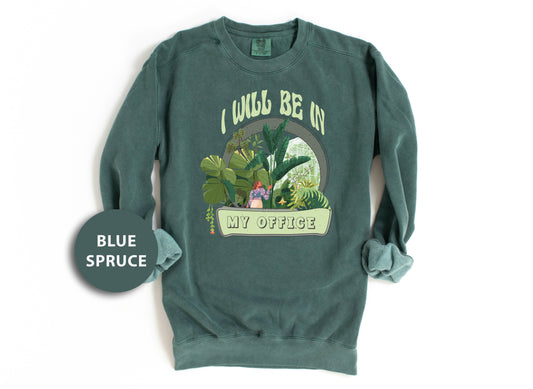 a green sweatshirt with a picture of a woman in a jungle