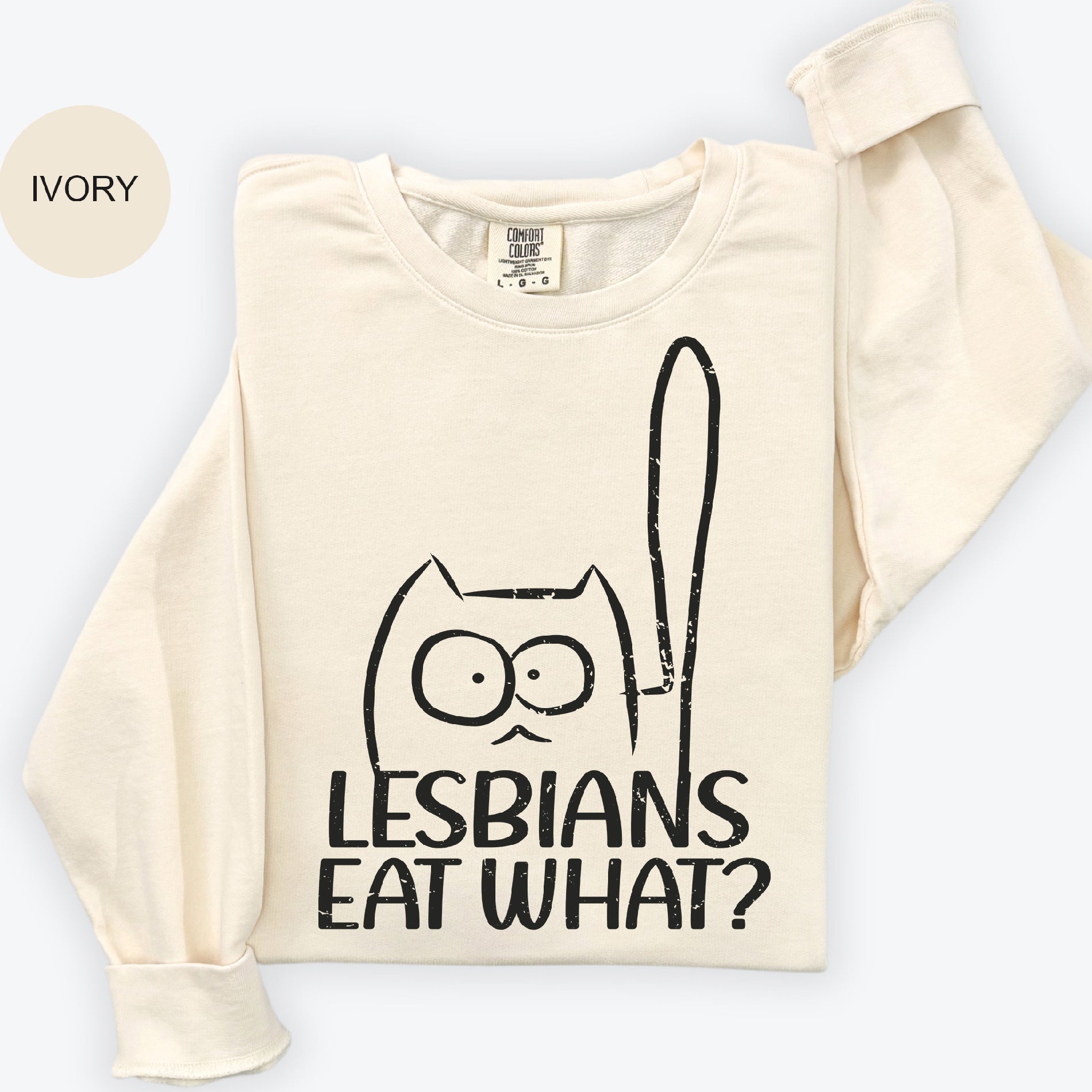 a t - shirt with a picture of a cat holding a spoon