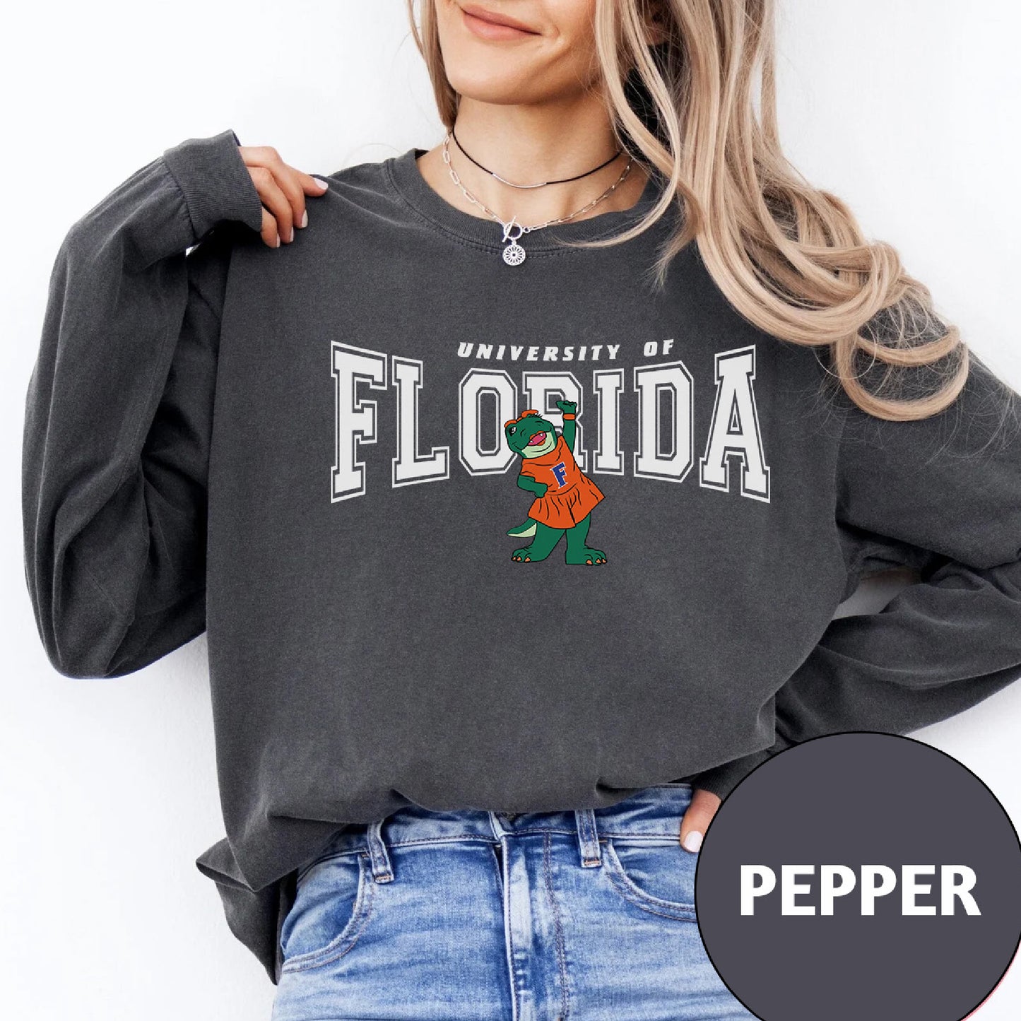 a woman wearing a sweatshirt with the university of florida mascot on it