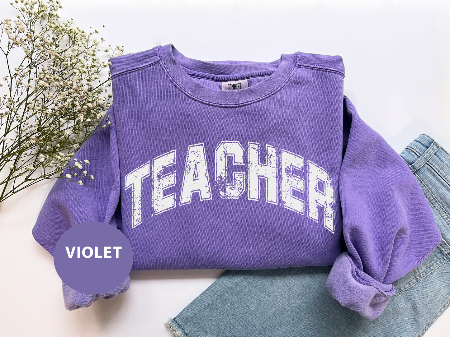 a purple sweatshirt with the word teacher on it