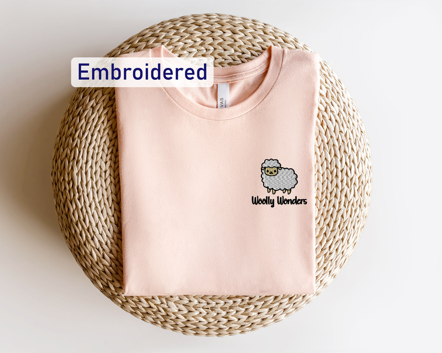 a pink shirt with a sheep embroidered on it