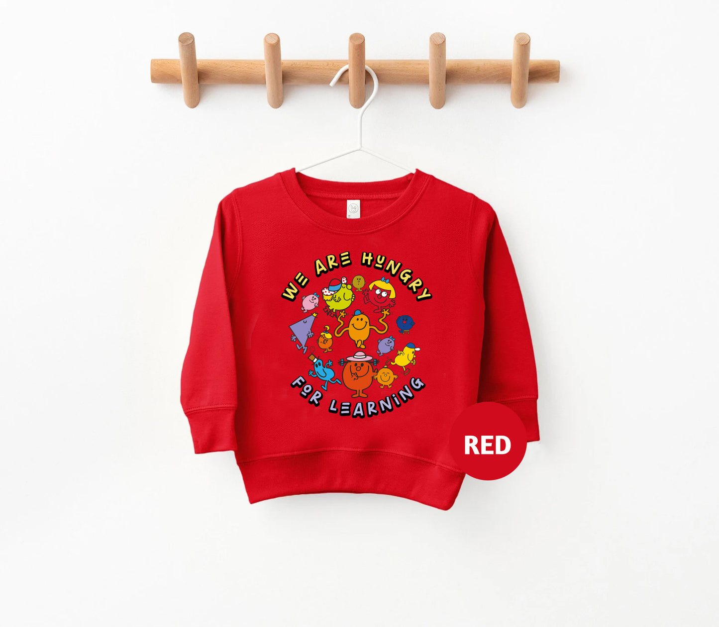 a red sweatshirt hanging on a wooden hanger