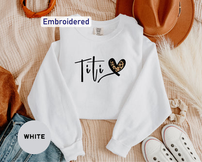 a white shirt with a heart and the word tit written on it