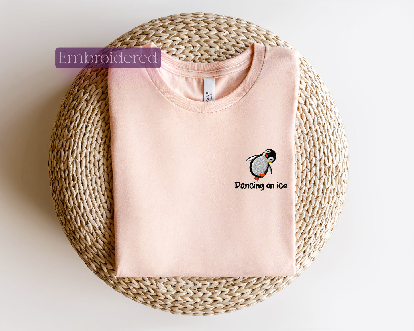 a pink t - shirt with a penguin on it