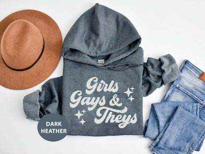 a hoodie, jeans and a hat on a white surface