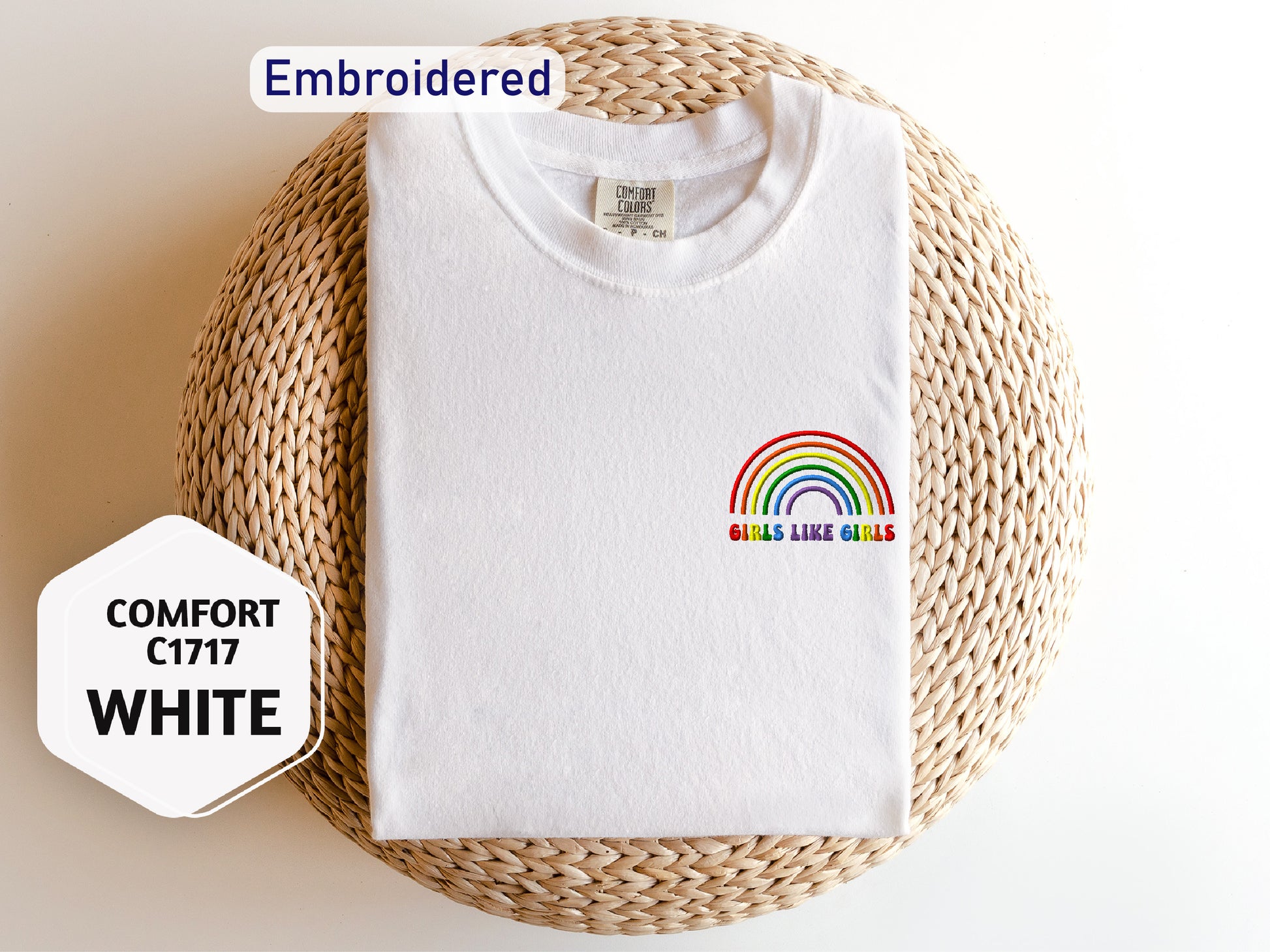 a white t - shirt with a rainbow embroidered on it