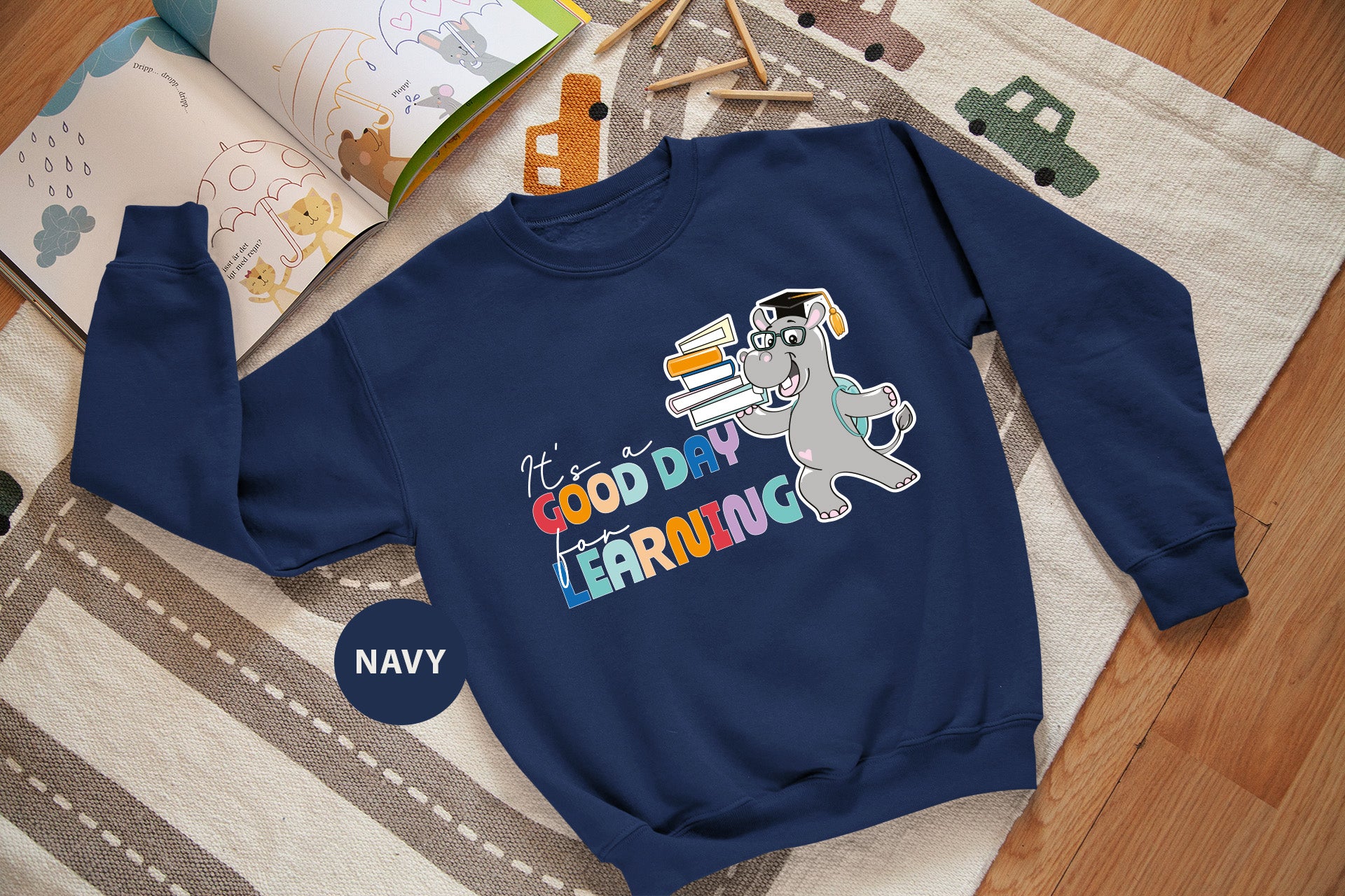 a blue sweatshirt with a cartoon character on it