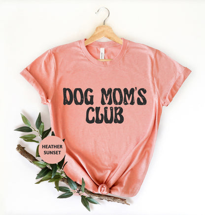 a pink dog mom's club t - shirt next to a t - shirt