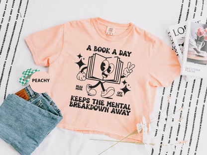 a t - shirt that says, a book a day keeps the mental breakdown