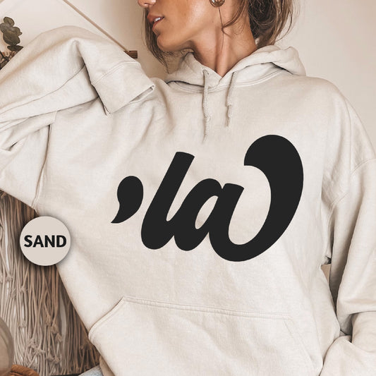 a woman wearing a white hoodie with the letter a on it