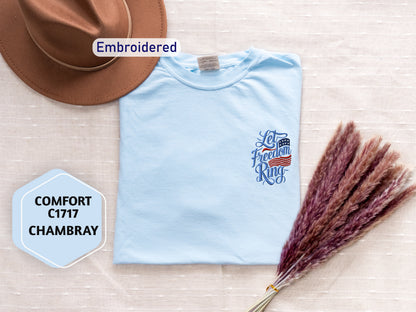 a light blue t-shirt with a patriotic design, a brown cowboy hat, and a bunch of red and brown flowers, all arranged on a beige background.