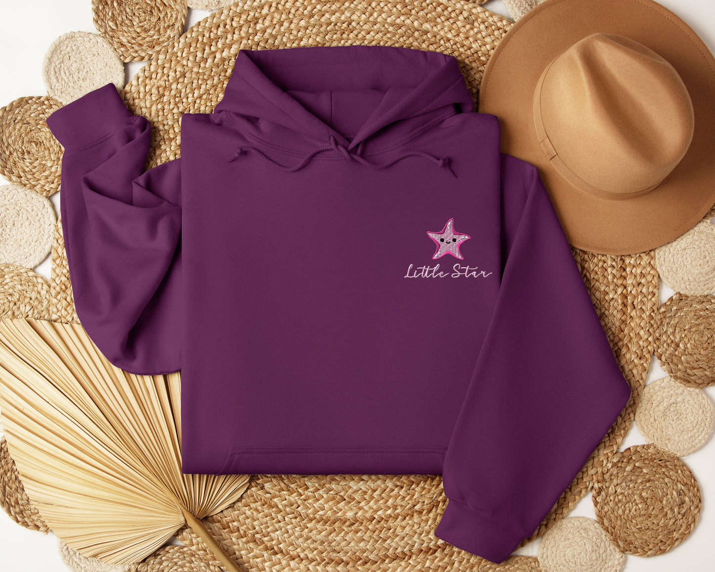 a purple hoodie with a pink star on it