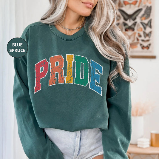 a woman wearing a green sweatshirt with the word pride on it