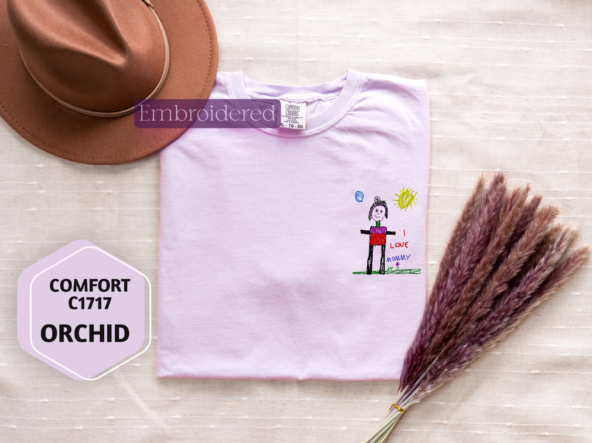 a hat, t - shirt, and dried grass on a table