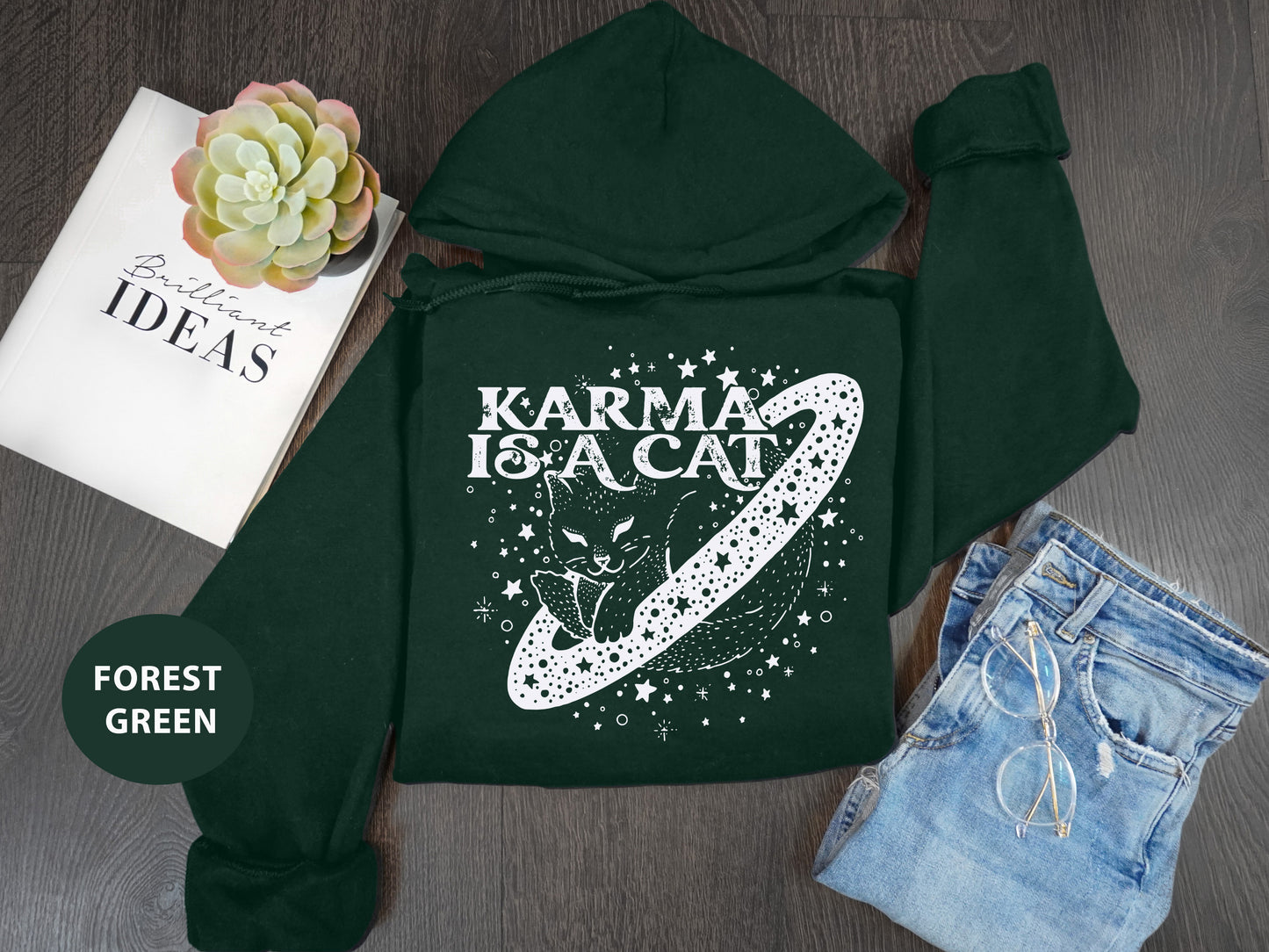 a green hoodie with the words karma is a cat on it