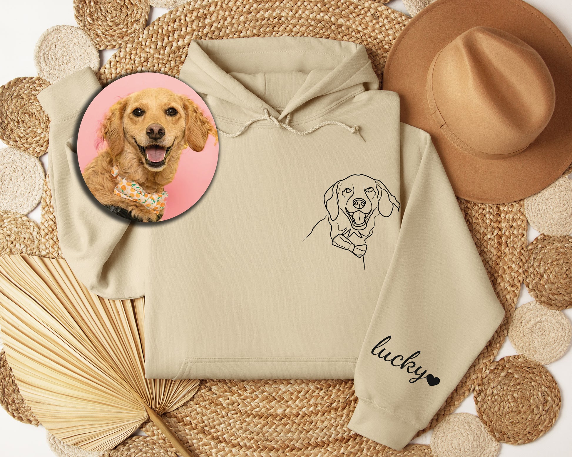 a picture of a dog on a hoodie next to a straw hat