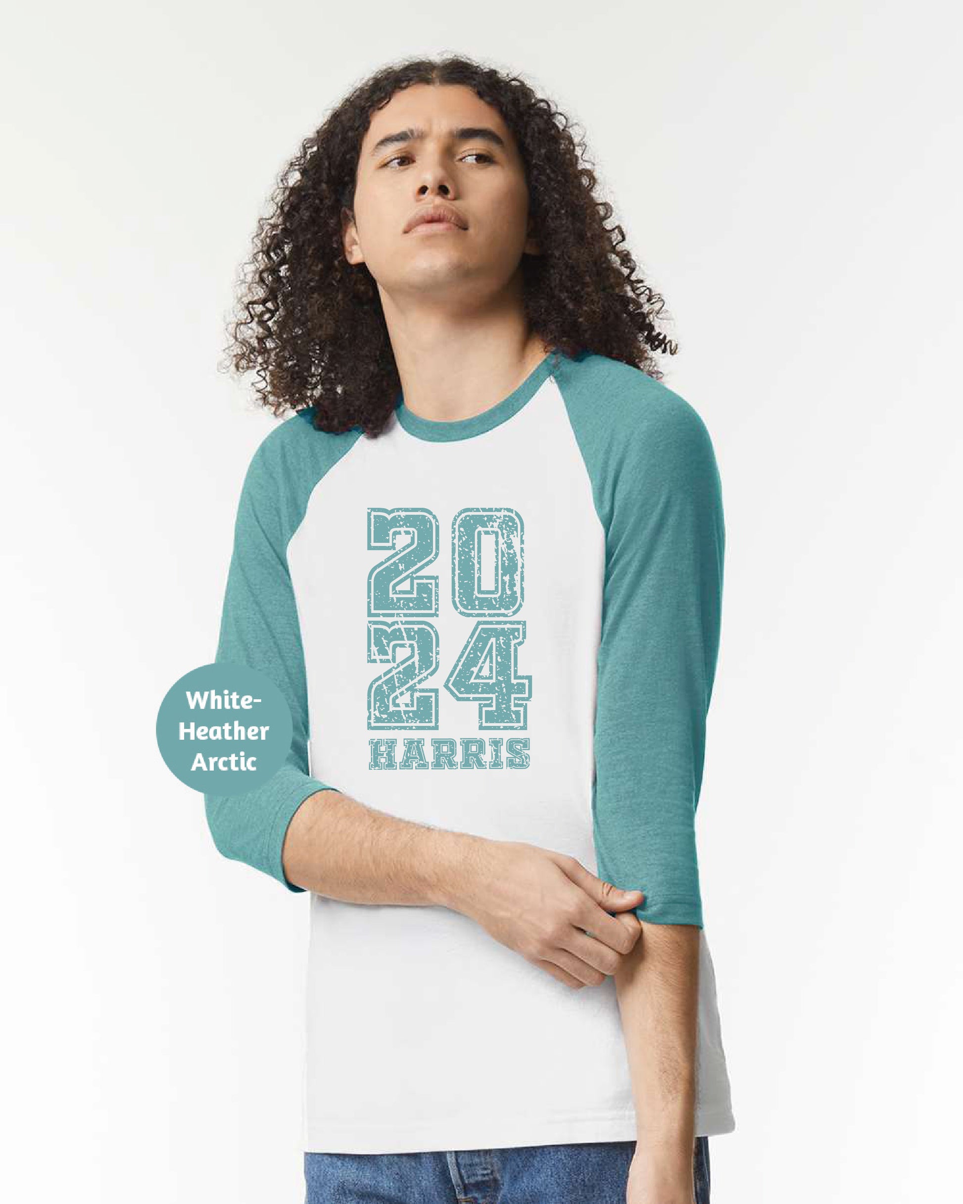 a man with curly hair wearing a white and teal baseball shirt