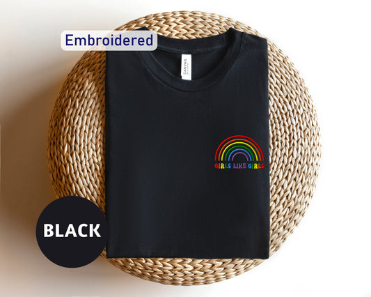 a black t - shirt with a rainbow embroidered on it