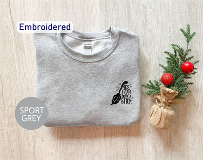 a t - shirt with a bird on it next to a christmas tree