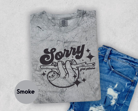 a t - shirt that says sorry and a pair of ripped jeans