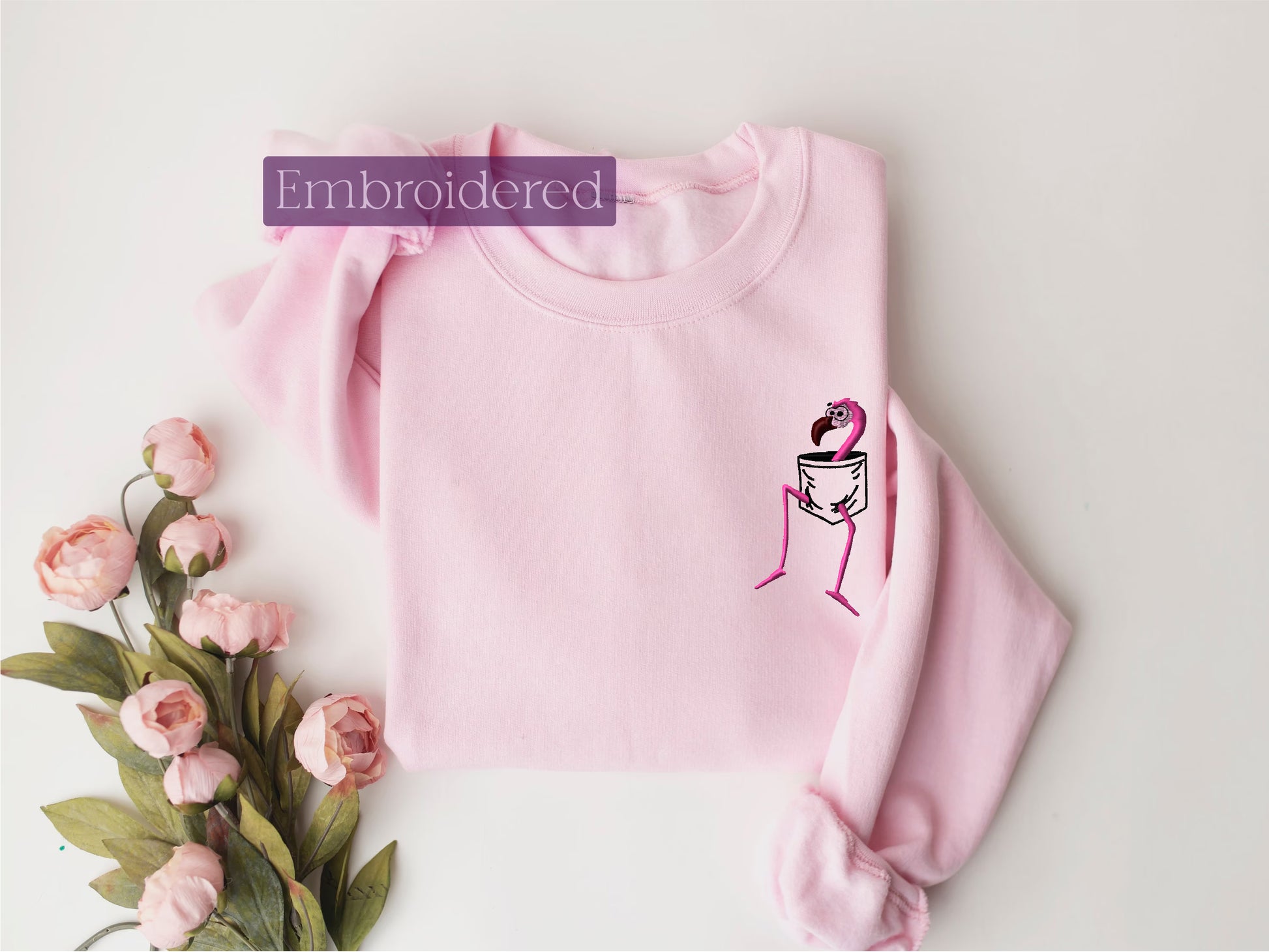 a pink sweater with a picture of a woman on it