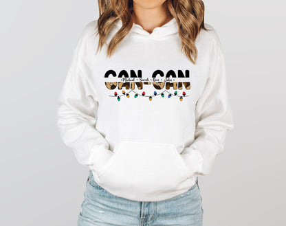 A woman wearing a white hoodie with the text "CAN CAN" printed on it.