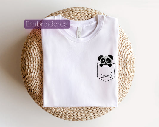 a white t - shirt with a panda in a pocket