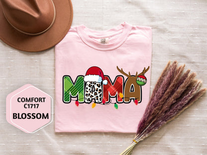 a pink t-shirt with a Christmas-themed design, a brown hat, and some decorative reindeer antlers.