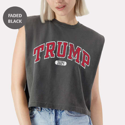 a woman with blonde hair wearing a crop top with the word trump printed on it