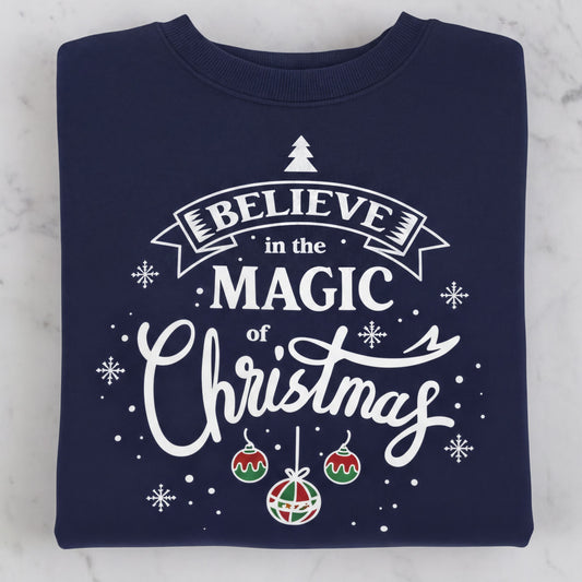 A navy blue sweatshirt with a white and red Christmas-themed design and text that reads "Believe in the Magic of Christmas".