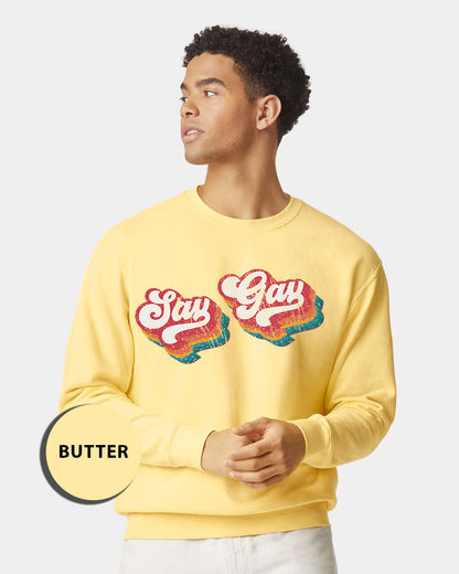 a man wearing a yellow sweatshirt with the words stay gay on it