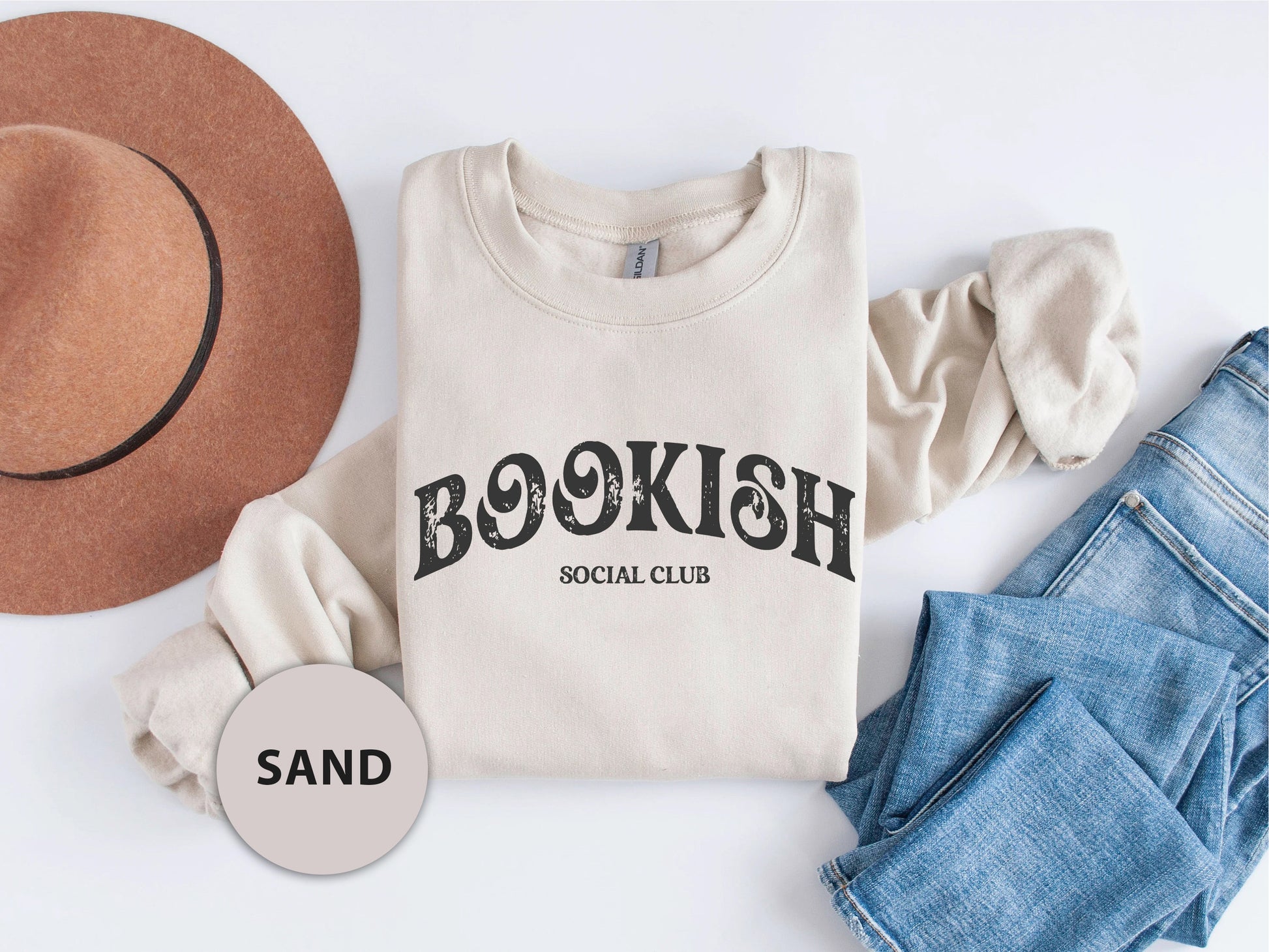 a shirt that says booksh social club next to a hat and jeans